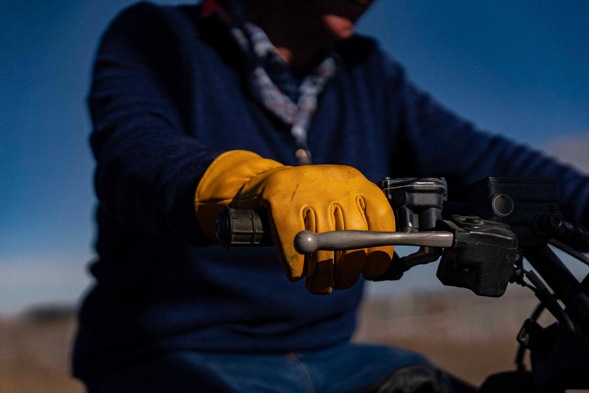 OR-OG driver gripping an ATV handlebar