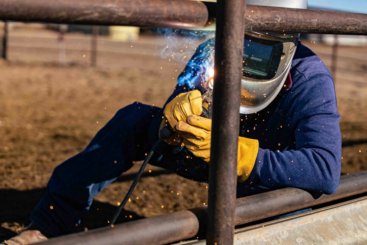 Welding a corral rail in OUTRIDER OR-WELD gloves
